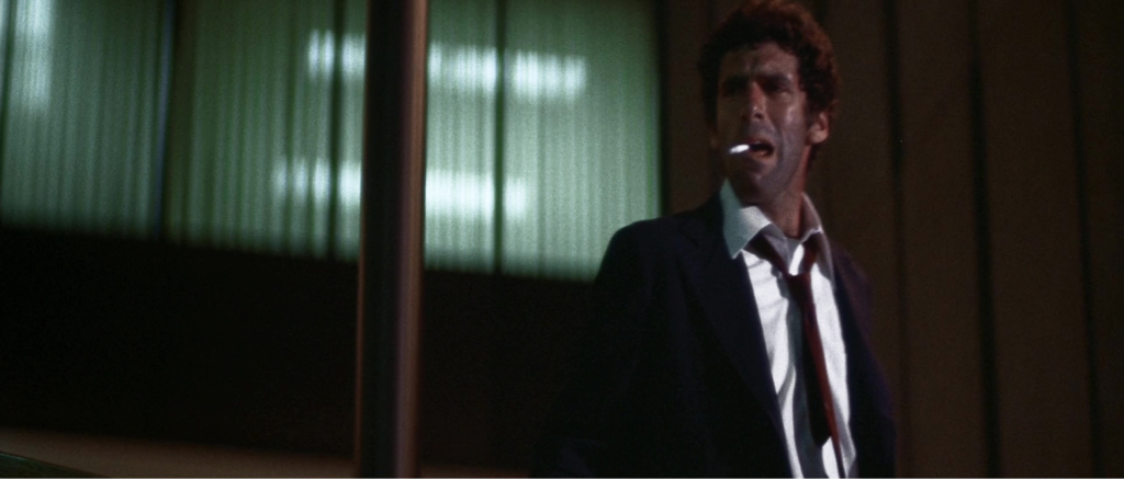 A man in a suit, caught in a quiet moment
