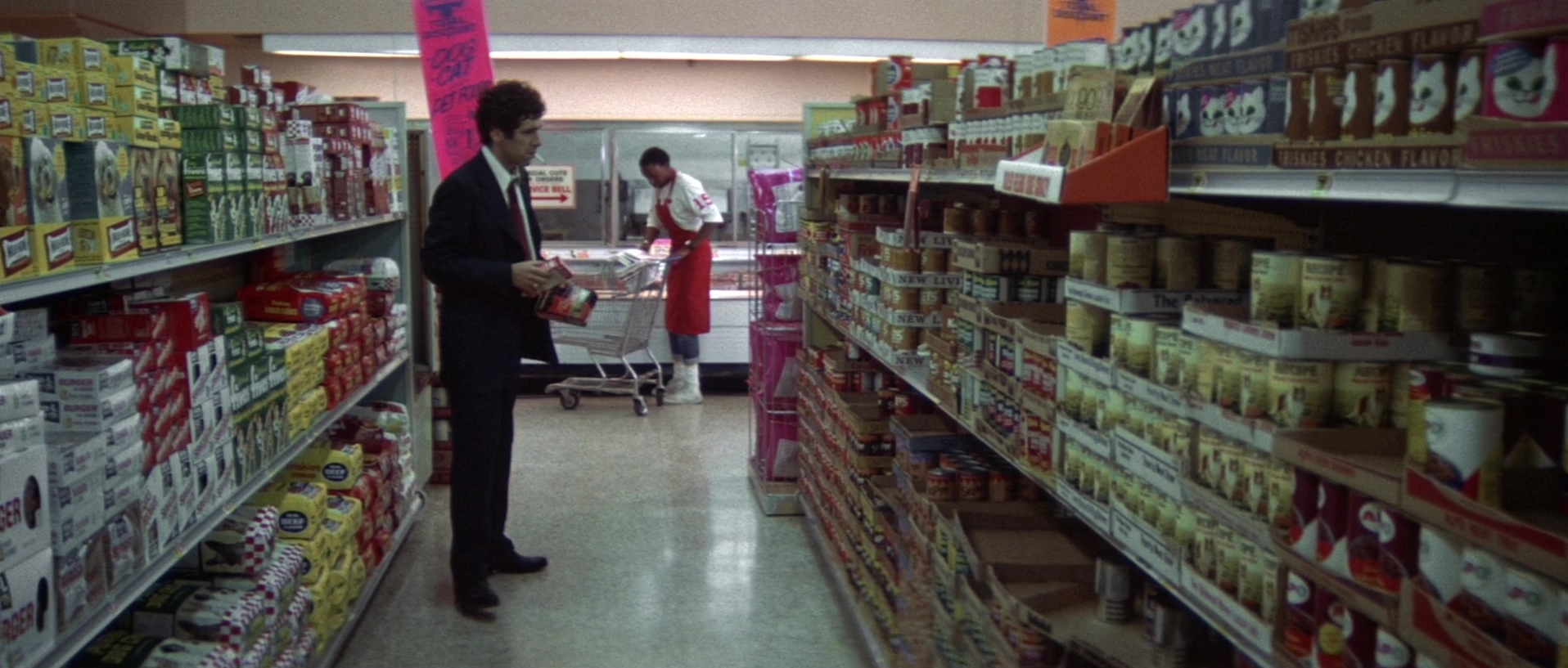 Two men in a neon-lit shop