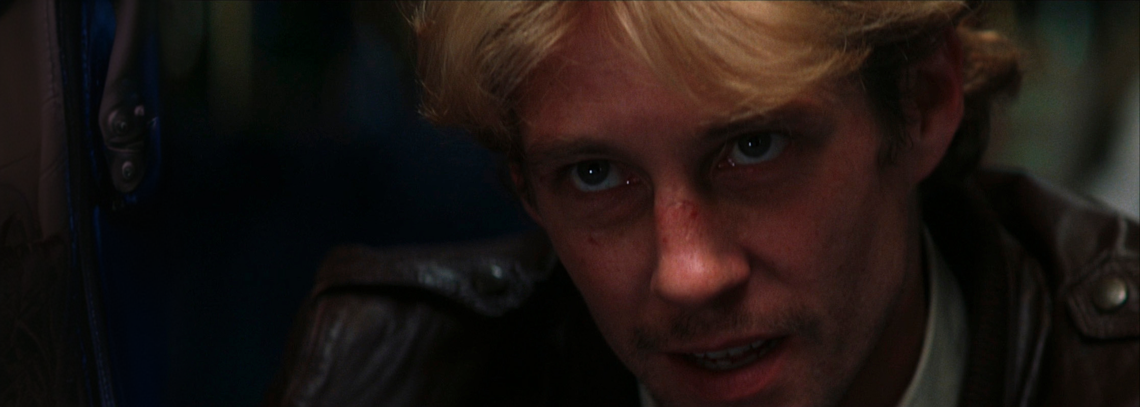An anxious man looking into camera